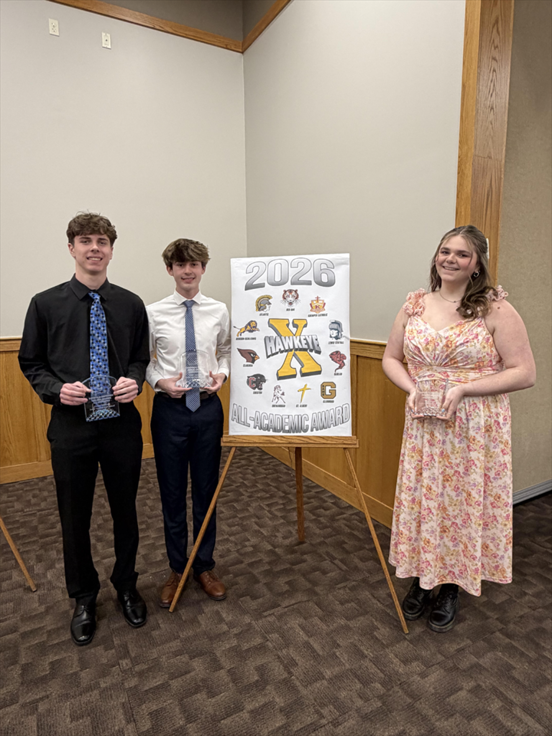 Amelia, Alexander, and Cooper holding their All-Academic Awards from the Hawkeye 10 Conference.