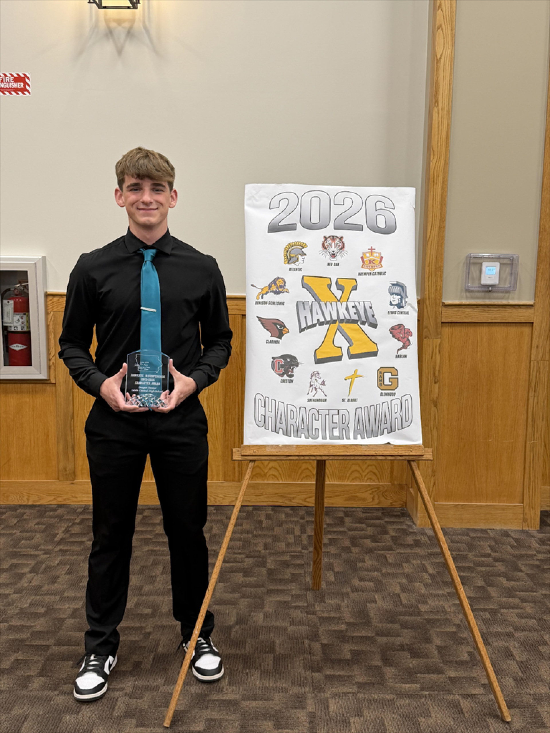 Deegan holding his Character Award from the Hawkeye 10 Conference.