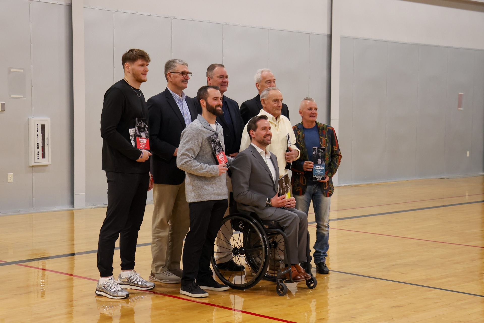 Eight inductees into the Council Bluffs Pro Sports Roster posing together with their awards.
