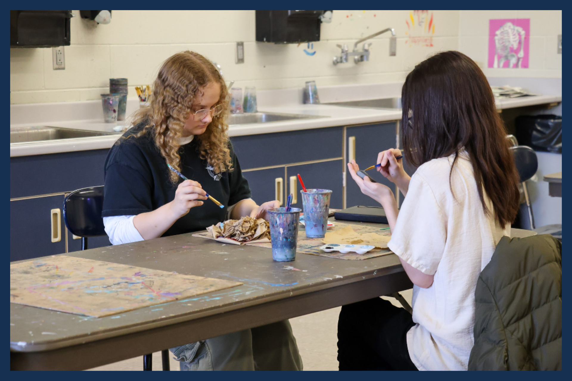 Students in the art room painting.