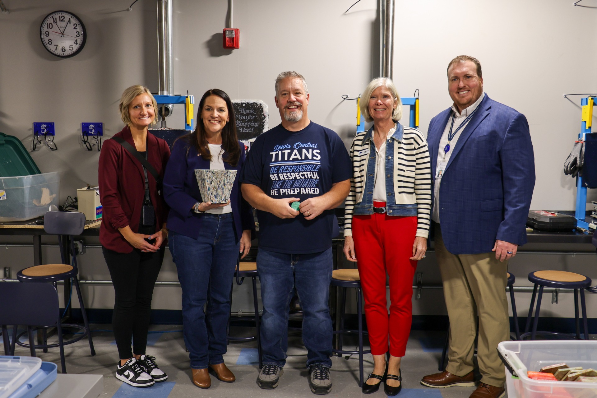 LCMS principal Dr. Reynolds, Lieutenant Governor Chris Cournoyer, Mr, Kern, an iJAG representative, and LC superintendent Dr. Hoesing posing in the plastic lab.