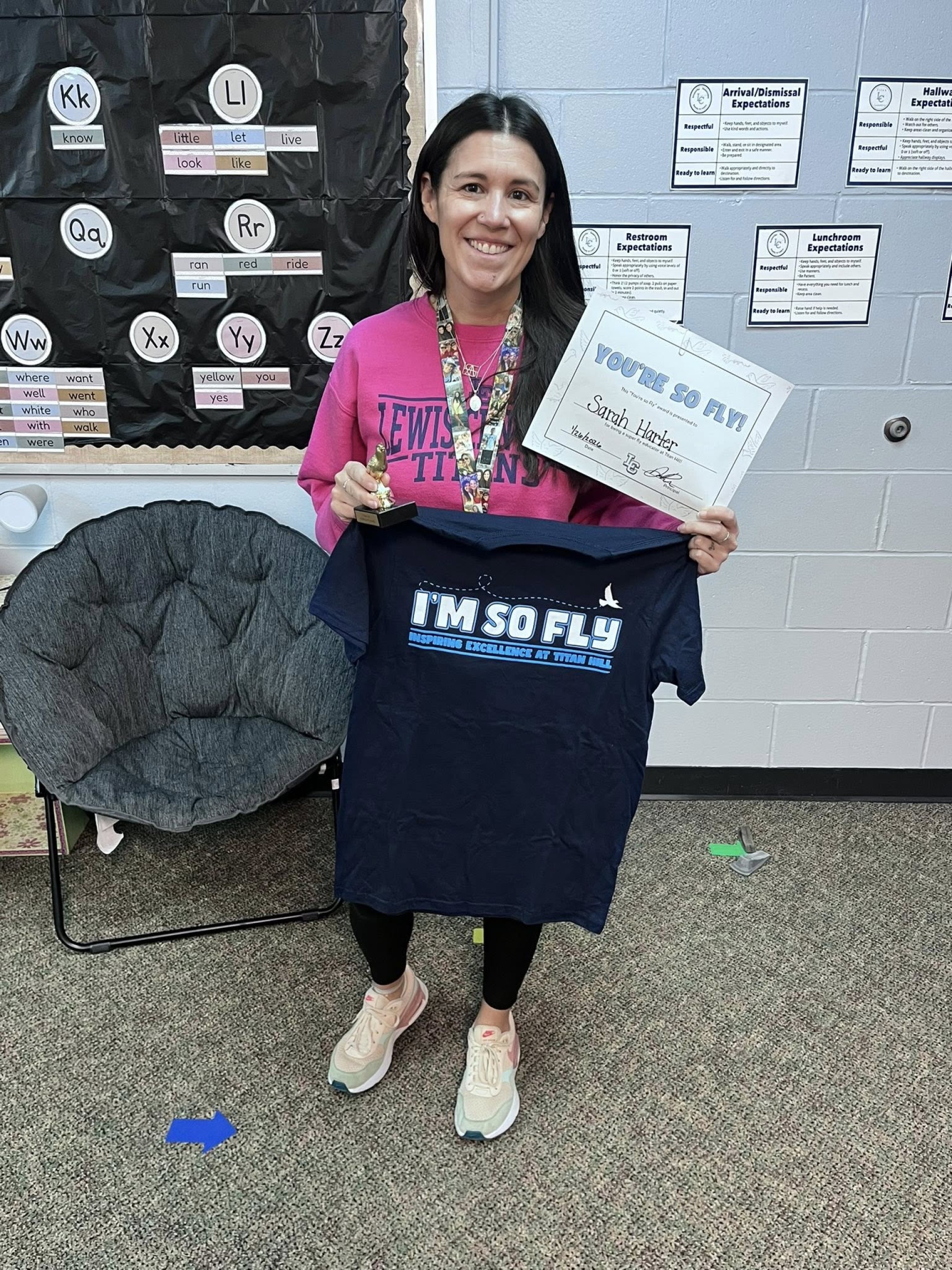 Ms. Harter, special education teacher, posing with her "You\'re so Fly" staff award.