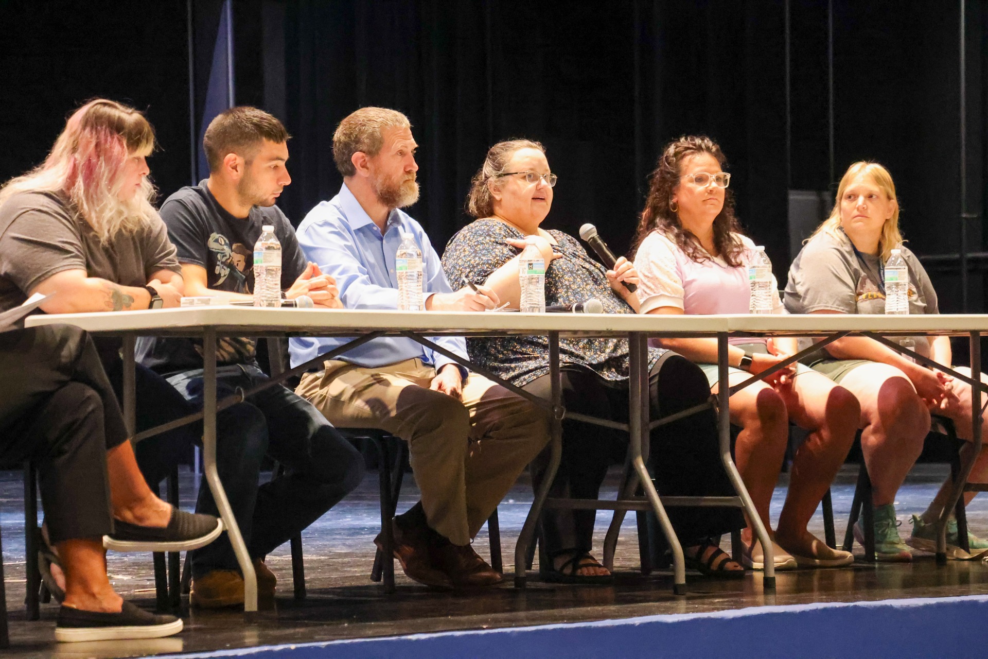 Five parents on stage participating in the Parent Panel discussion