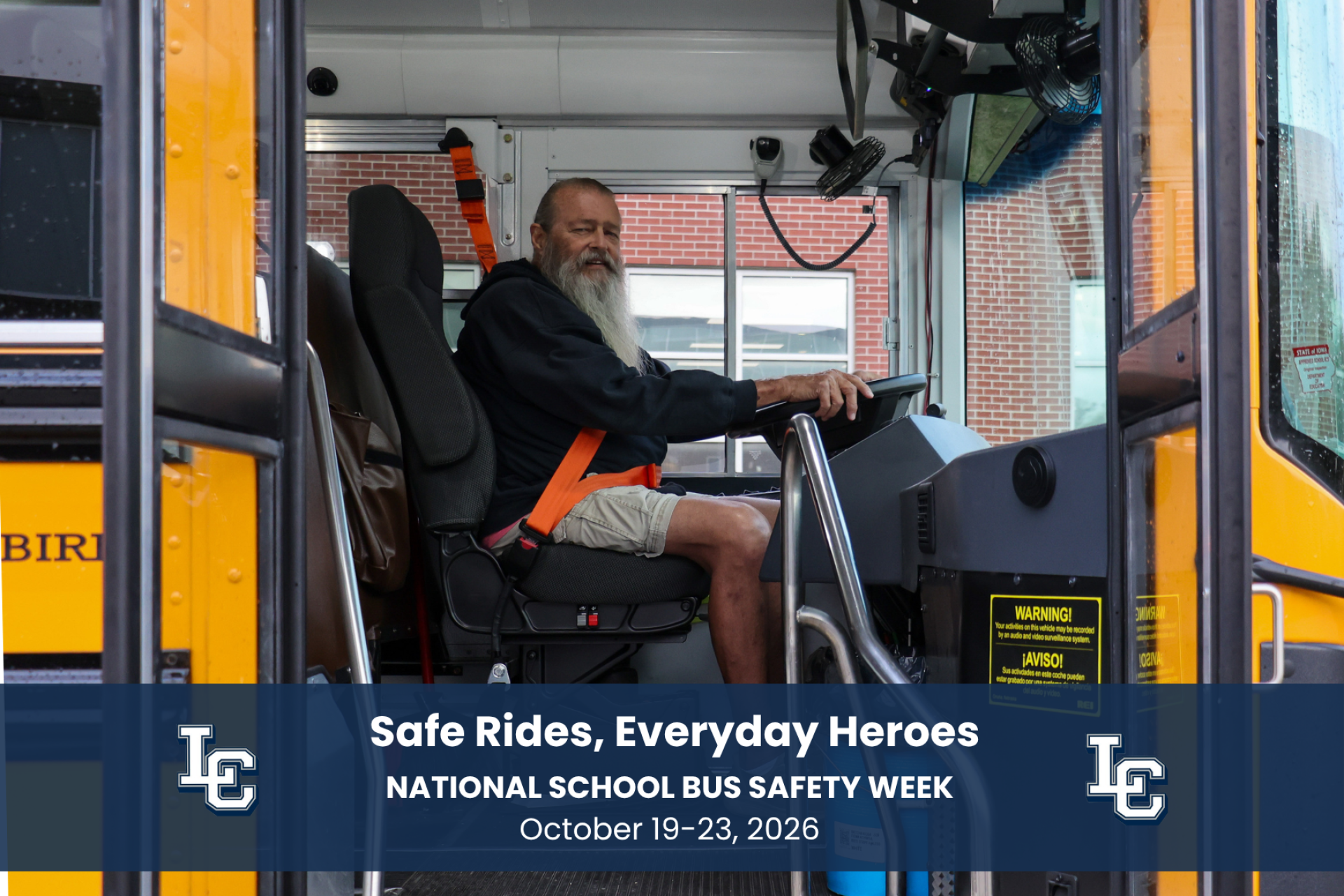 A school bus driver sitting in the seat of the bus.