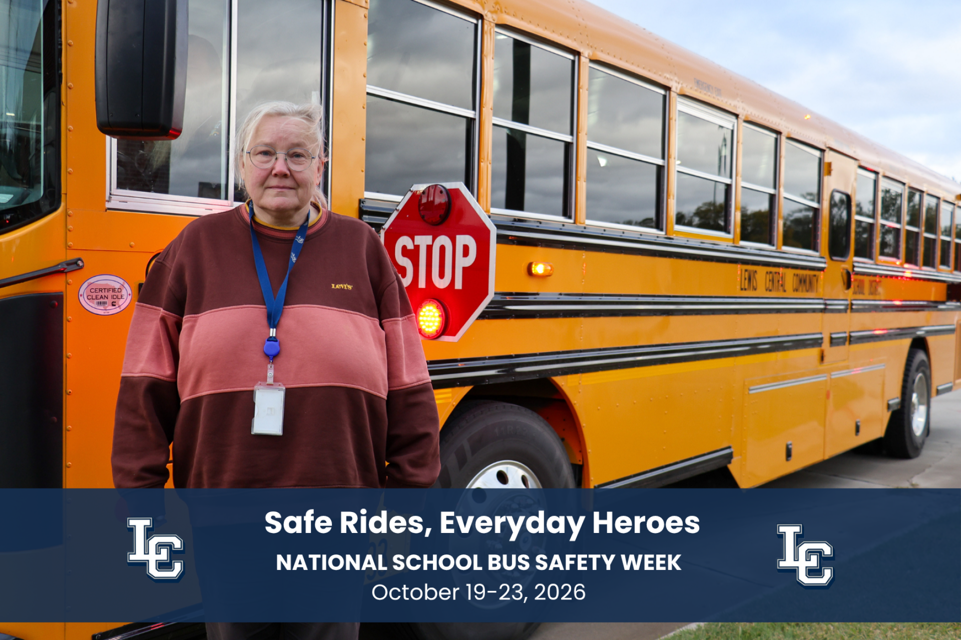 A school bus driver standing next to the bus with the stop sign and lights on.