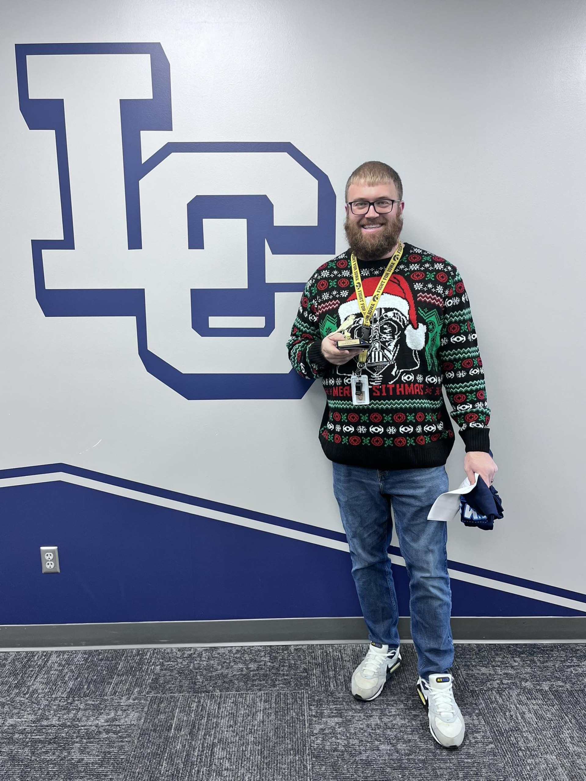 Mr. Fast, 5th grade teacher, with his "You\'re so Fly" award in hand.