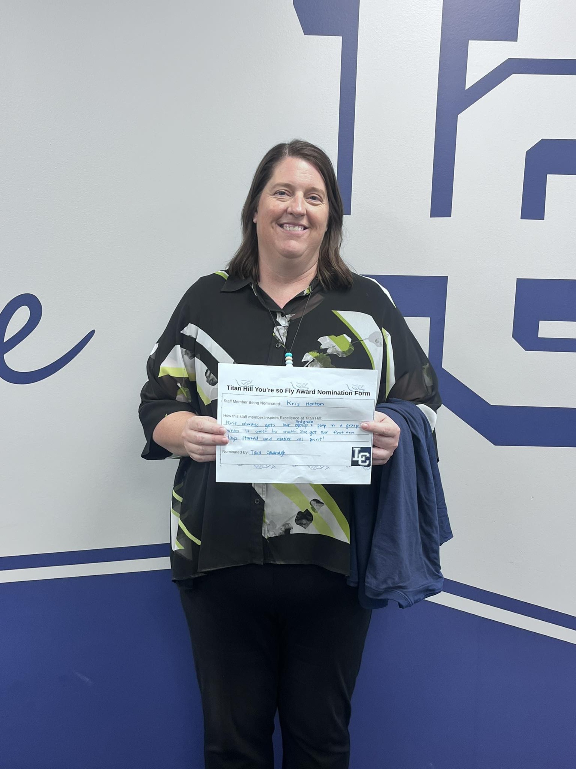 Mrs Horton holding her "Youre so Fly" award